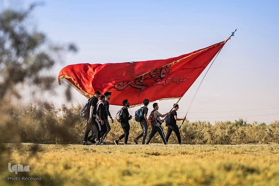 A group of youth walking toward Karbala during Arbaeen procession in September 2022.