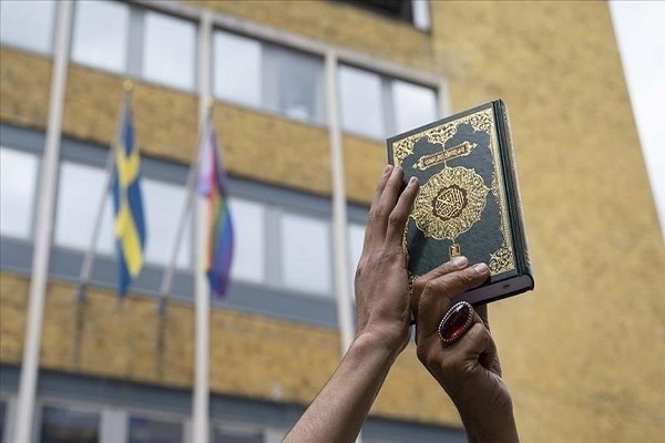 Muslim man holding a copy of the Quran