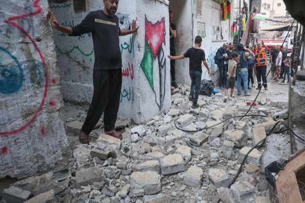 Palestinian emergency personnel and residents inspect the damage following the Israeli raid on Balata refugee camp in the occupied West Bank