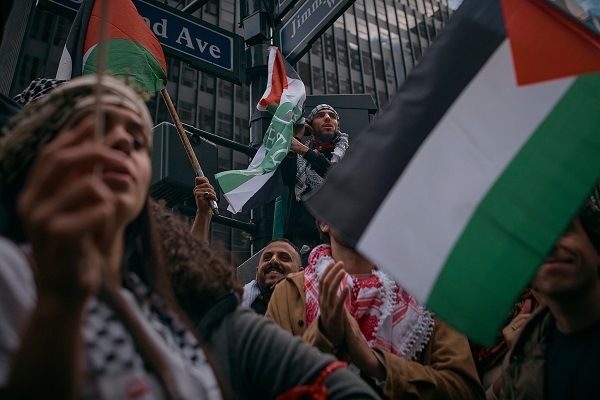 Muslim Americans holding Palestinian flags, supporting Gaza