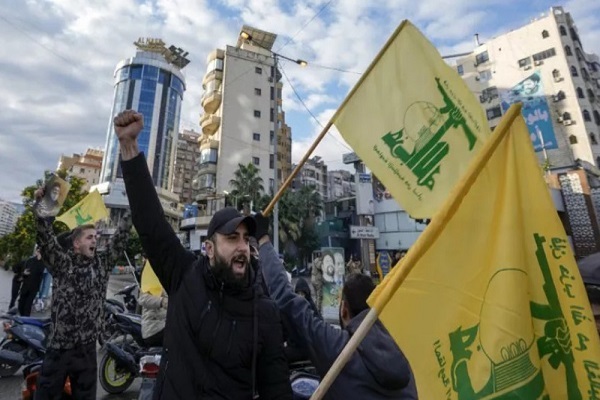 Lebanese people celebrate, carrying Hezbollah’s flags in the capital Beirut on November 27, 2024.