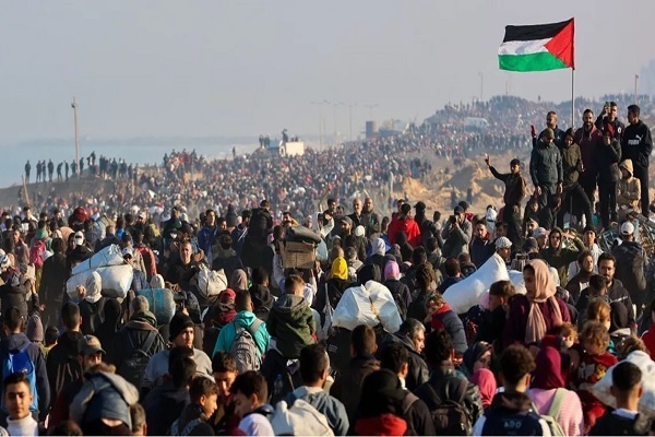 Palestinians holding up a flag of Palestine in a gathering in Gaza