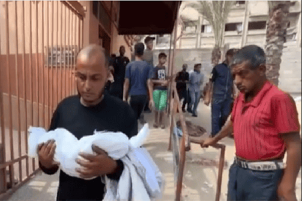 A father carries the body of his infant girl who died as a result of starvation caused by Israeli siege on Gaza.