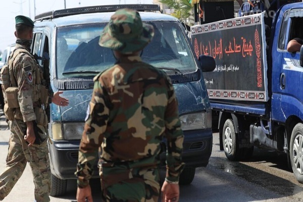 Arbaeen security forces stop a car on the road between Najaf and Karbala in Iraq.