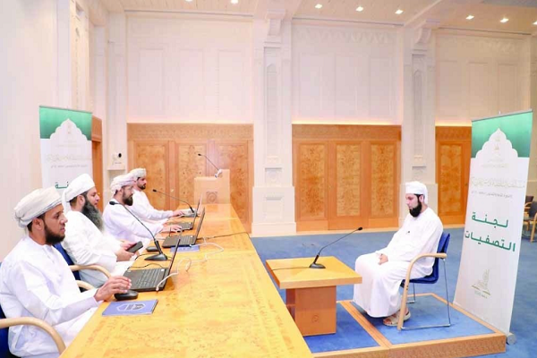 A participants in the Sultan Qaboos Holy Quran Competition in Oman answers questions of the panel of judges.