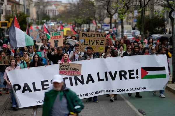 People carry a banner with the words ‘Free Palestine’ during a demonstration demanding a ceasefire in Gaza and in support of Palestinians, in Lisbon, Portugal, on April 7, 2024.
