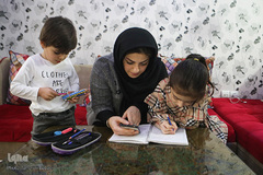 سعیده مادر سلاله در حال آموزش فایل‌های آموزشی که مدرسه ارسال کرده است؛‌ در این روزها مدارس به علت شیوع بیماری کرونا تعطیل هستند و آموزش از راه دور دارند.