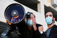 یک کارشناس نجوم فلسطینی با تلسکوپ در حال رصد هلال اول ماه رمضان در شهر "الخلیل- حبرون" سرزمین‌های اشغالی کرانه باختری رود اردن