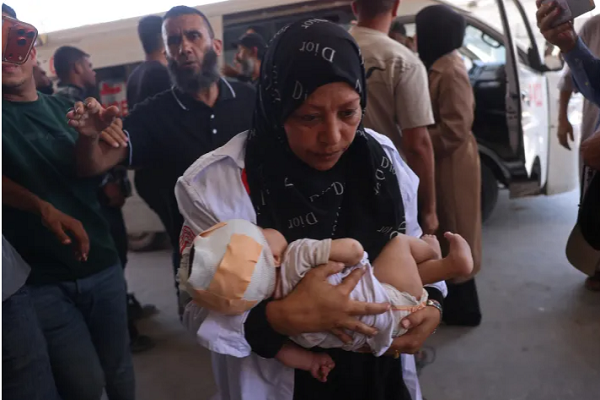 A Palestinian nurse carries an injured child at Nasser Hospital in Khan Younis in the southern Gaza Strip, following a reported Israeli strike on a displacement camp in al-Mawasi, on June 27, 2026