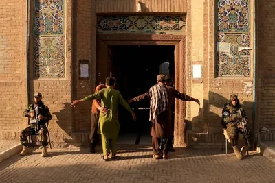Security personnel frisk devotees entering Jami mosque in Herat, western Afghanistan, to offer Eid Al Adha prayers. AFP

