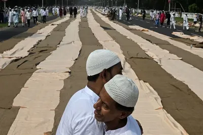 Devotees greet each other after offering Eid Al Adha prayers in Kolkata, north-east India. AFP

