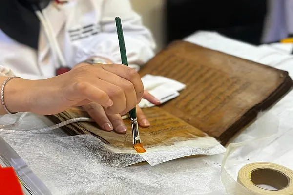 من رماد القرون: خبراء إماراتيون يُحيون مخطوطة مصحف