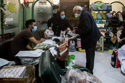 آقای نعمتی در حال صحبت با همکاران و گرفتن فهرست اسامی خانواده‌هاست.