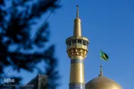 اهتزاز پرچم عزای حسینی بر فراز گنبد حرم رضوی
